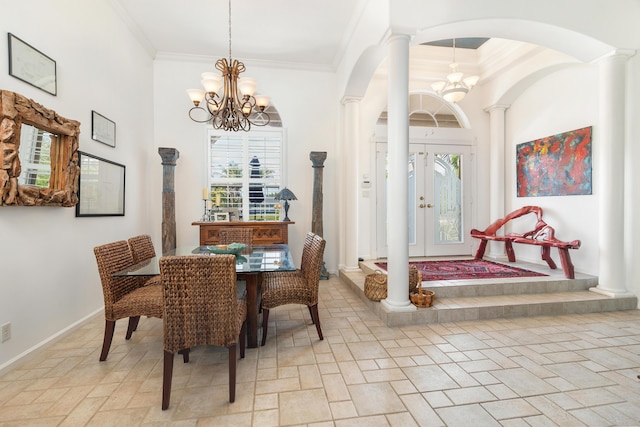 dining area featuring decorative columns, a chandelier, arched walkways, crown molding, and stone tile flooring