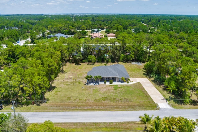 view from above of property with a heavily wooded area