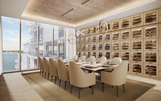 dining area with a tray ceiling, a water view, and floor to ceiling windows