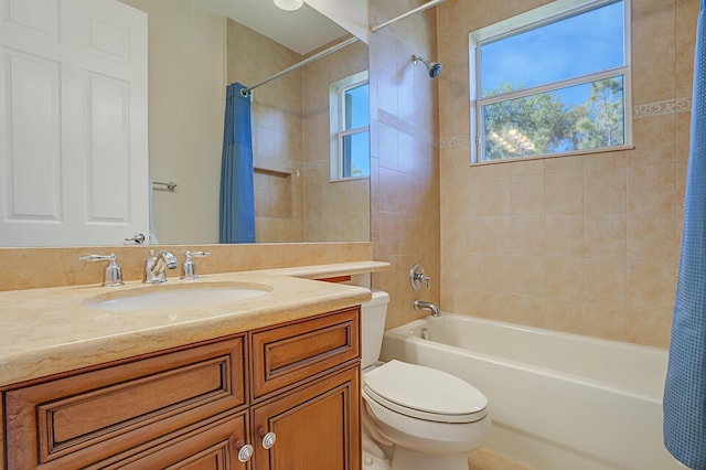 full bath featuring shower / bath combination with curtain, toilet, and vanity