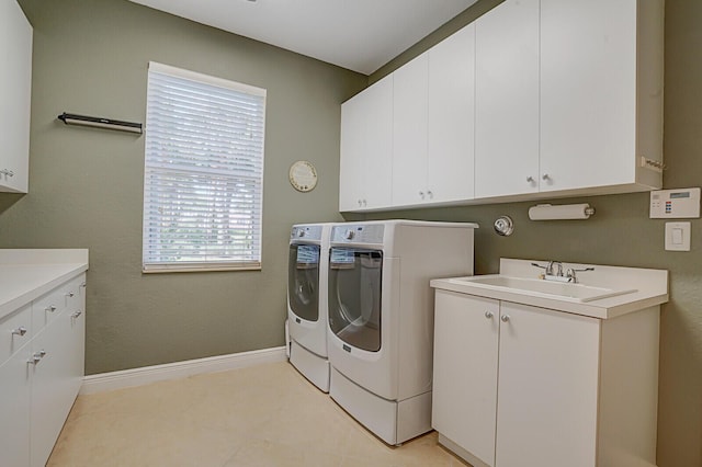 10733 Castle Oak Dr, Boynton Beach, FL 33473 - washroom with a sink, cabinet space, baseboards, and washing machine and clothes dryer