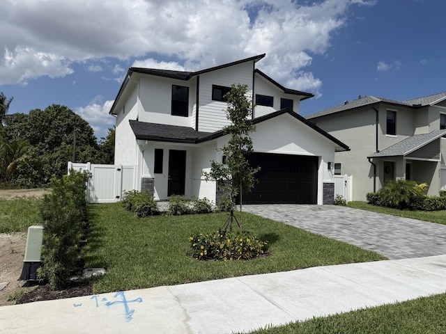 580 Lucky Ln, Delray Beach, FL 33444 - contemporary house featuring a front yard, a garage, stucco siding, a gate, and decorative driveway