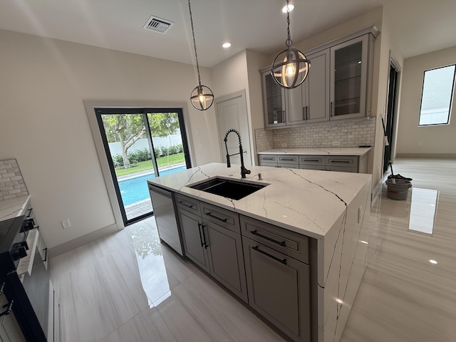 580 Lucky Ln, Delray Beach, FL 33444 - kitchen with gray cabinets, visible vents, a healthy amount of sunlight, stainless steel dishwasher, and a sink