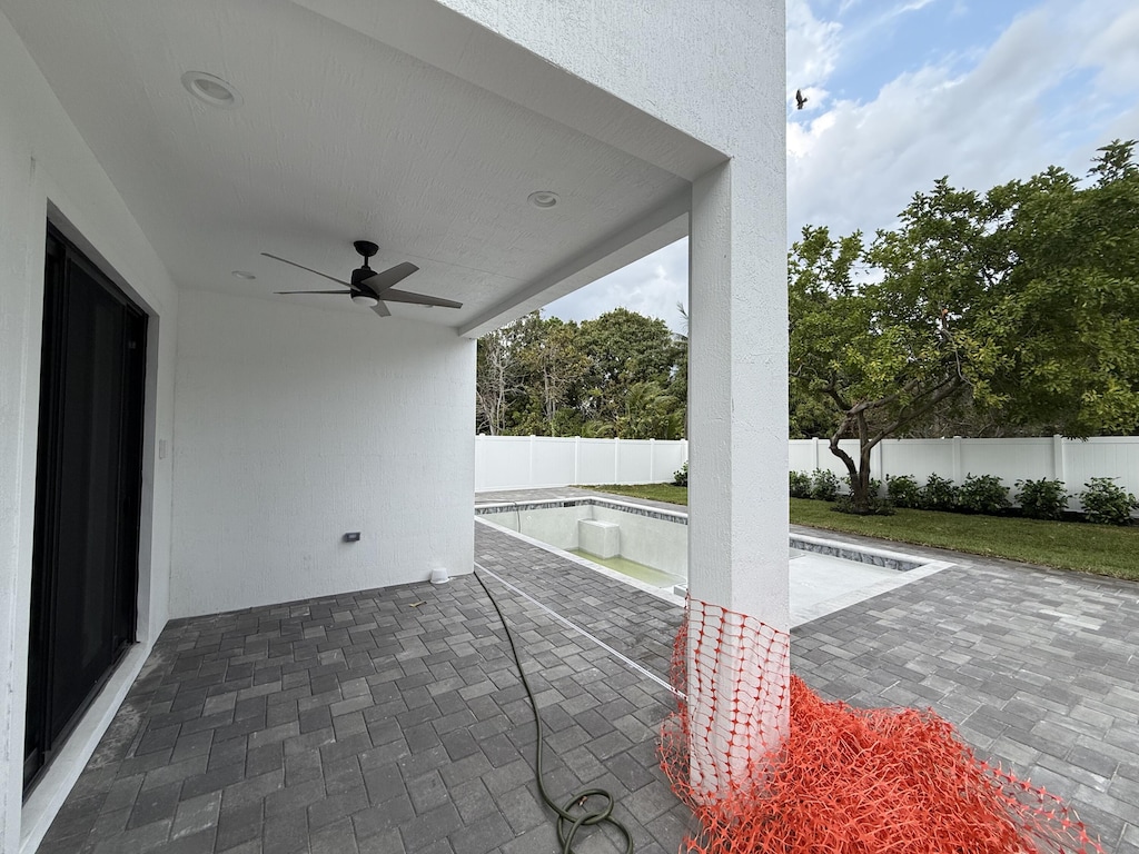 view of patio with a fenced backyard, a fenced in pool, and a ceiling fan