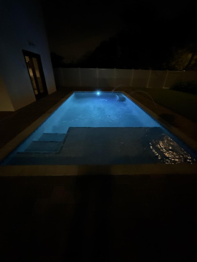 580 Lucky Ln, Delray Beach, FL 33444 - pool at twilight featuring fence