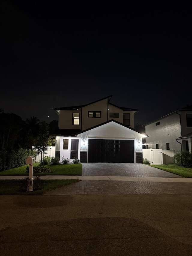 580 Lucky Ln, Delray Beach, FL 33444 - view of front of property featuring a garage, fence, stucco siding, a gate, and decorative driveway