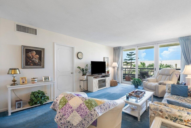 living room with visible vents, a textured ceiling, and carpet flooring