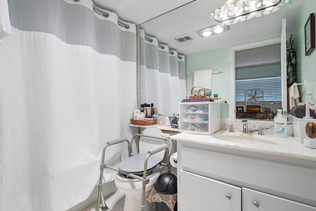 bathroom with visible vents, a shower with curtain, and vanity