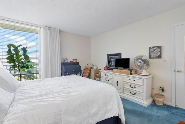 carpeted bedroom featuring a textured ceiling and access to outside