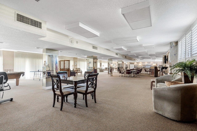 dining area featuring visible vents, a textured ceiling, and carpet floors