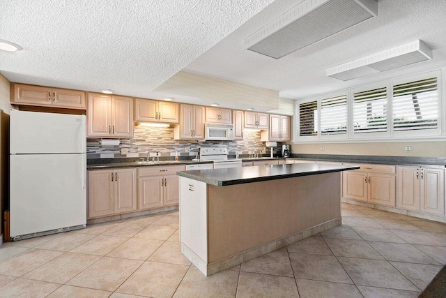 kitchen featuring a sink, a center island, white appliances, light tile patterned flooring, and decorative backsplash