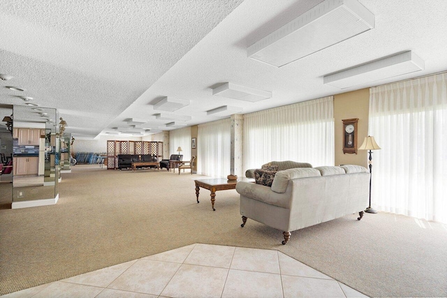 carpeted living area with a textured ceiling and tile patterned flooring