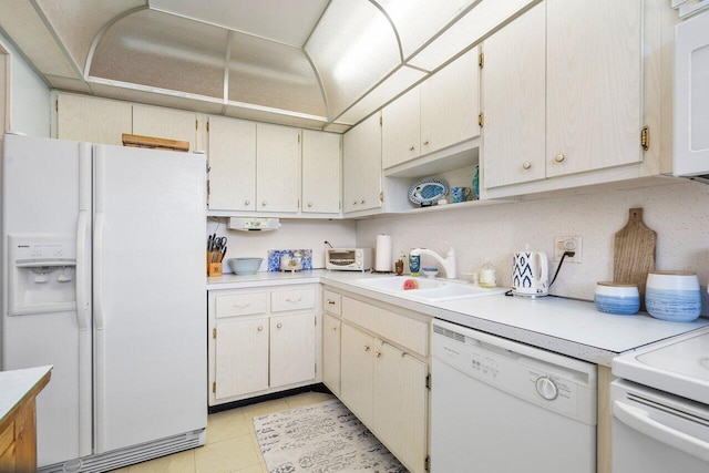 kitchen featuring a sink, open shelves, white appliances, light countertops, and light tile patterned floors