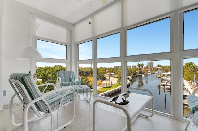 sunroom / solarium featuring a water view