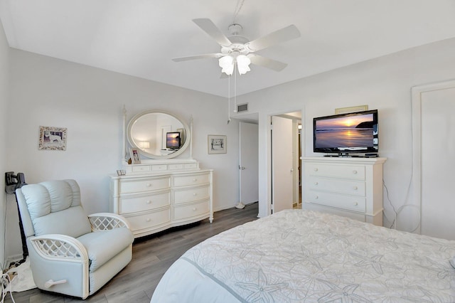 bedroom featuring wood finished floors, visible vents, and ceiling fan