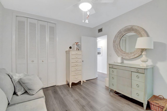 bedroom with visible vents, light wood-style floors, a closet, and a ceiling fan