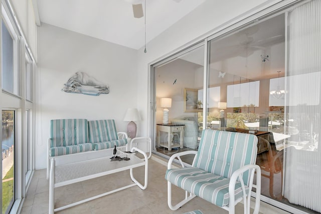 sunroom featuring a ceiling fan