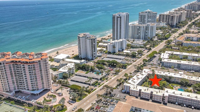 birds eye view of property with a view of city and a water view