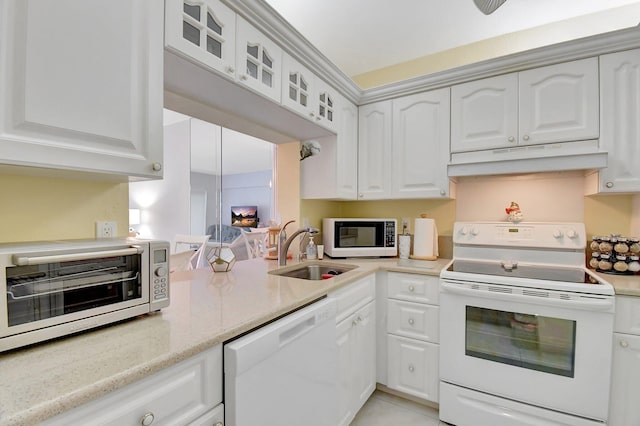 kitchen featuring white cabinetry, white appliances, under cabinet range hood, and a sink