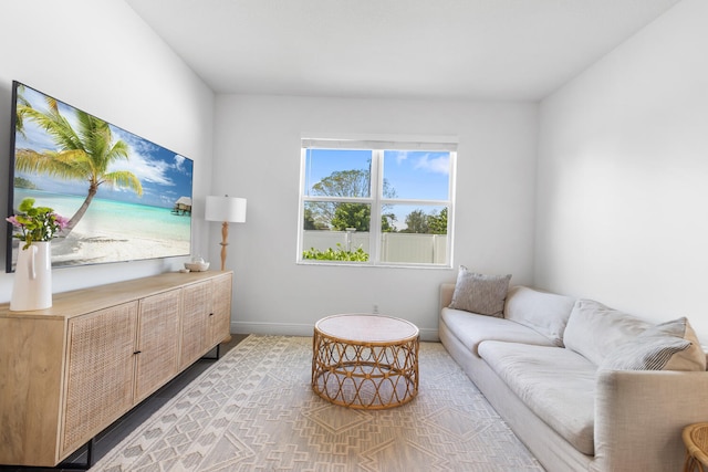 living area featuring baseboards