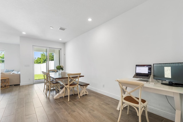 dining space featuring baseboards, plenty of natural light, and light wood-style floors