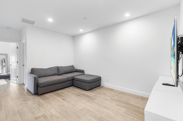 living area featuring visible vents, recessed lighting, baseboards, and light wood-style floors