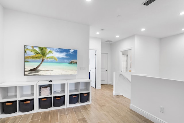 corridor featuring recessed lighting, wood finished floors, visible vents, and baseboards