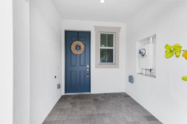 view of exterior entry featuring stucco siding