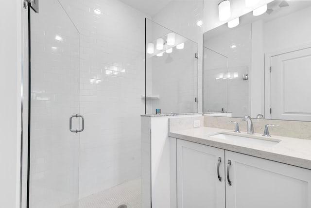 full bath with vanity and a shower stall