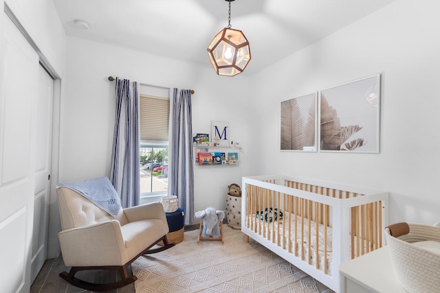 bedroom with a closet and a crib