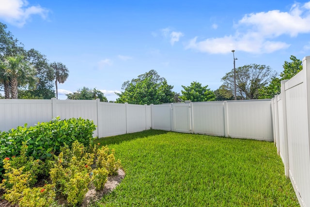 view of yard with a fenced backyard