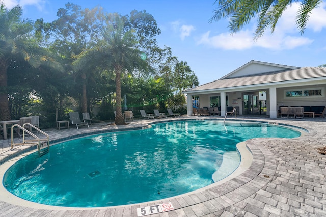 community pool featuring outdoor lounge area and a patio area