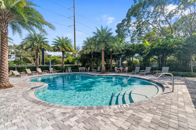 community pool featuring fence and a patio area