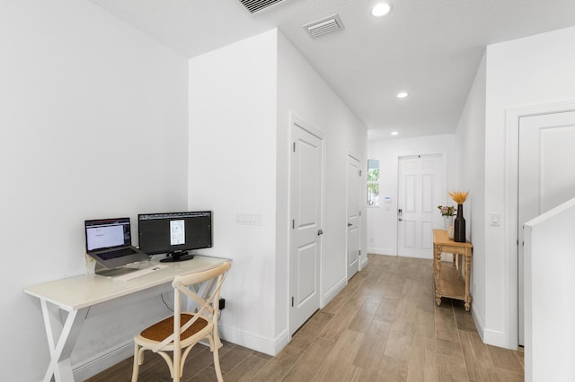 office space featuring recessed lighting, wood finished floors, visible vents, and baseboards