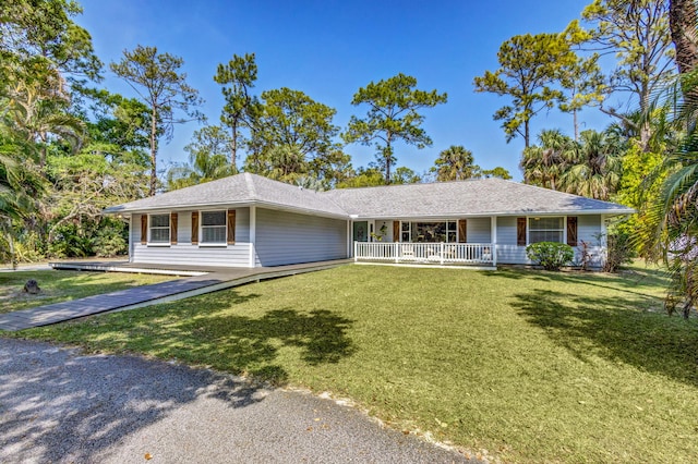 single story home featuring covered porch and a front lawn