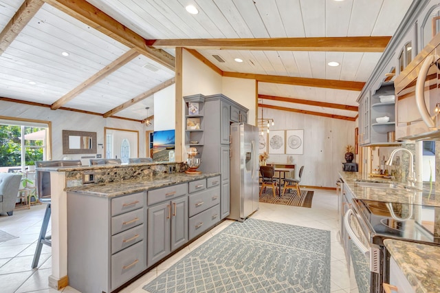 kitchen with light tile patterned floors, open shelves, lofted ceiling with beams, gray cabinetry, and appliances with stainless steel finishes