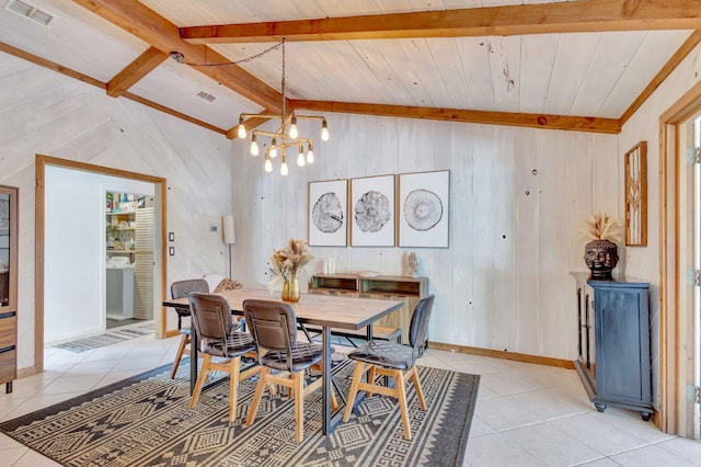 dining area with visible vents, baseboards, lofted ceiling with beams, an inviting chandelier, and light tile patterned flooring