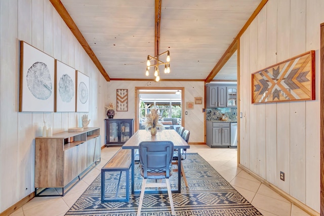 dining area featuring light tile patterned flooring and wood walls