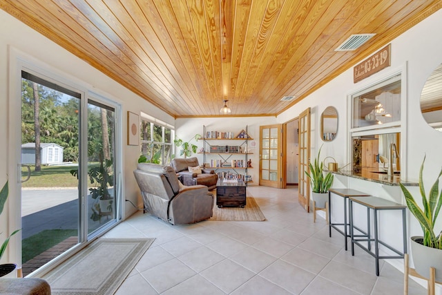 interior space featuring light tile patterned floors, wood ceiling, visible vents, and ornamental molding