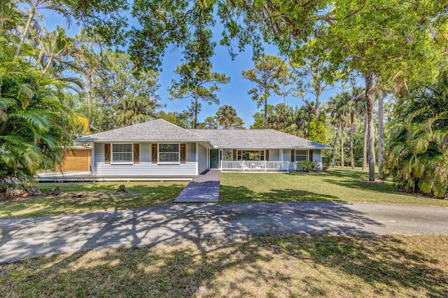 single story home with a porch and a front lawn