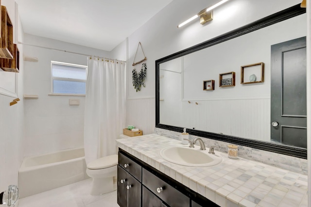 bathroom featuring a wainscoted wall, toilet, shower / bath combo, tile patterned floors, and vanity