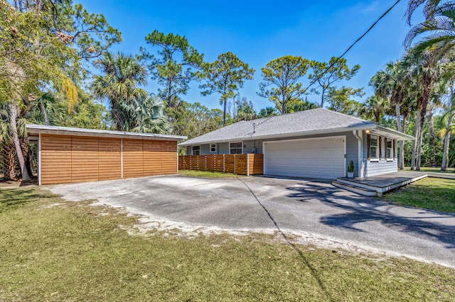 exterior space with driveway, an attached garage, and a yard