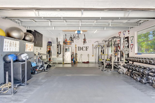 garage featuring freestanding refrigerator and a garage door opener