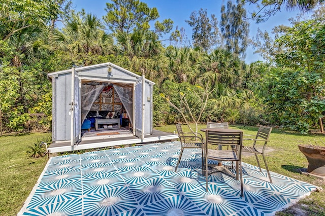 view of patio with outdoor dining space and an outdoor structure