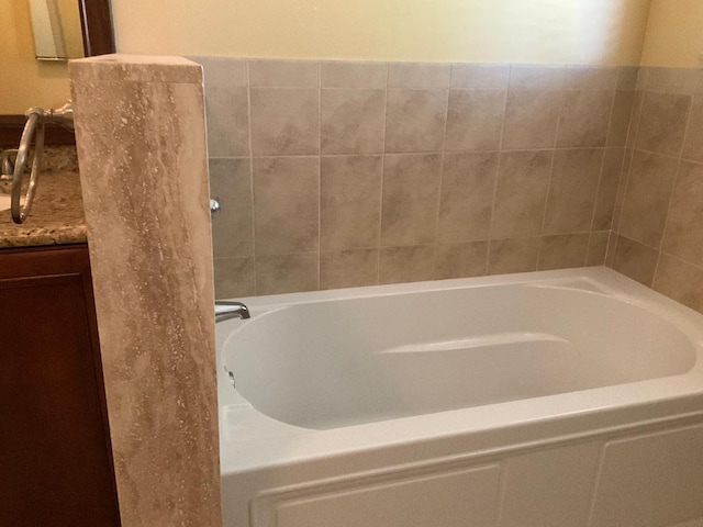 bathroom featuring vanity and a tub to relax in