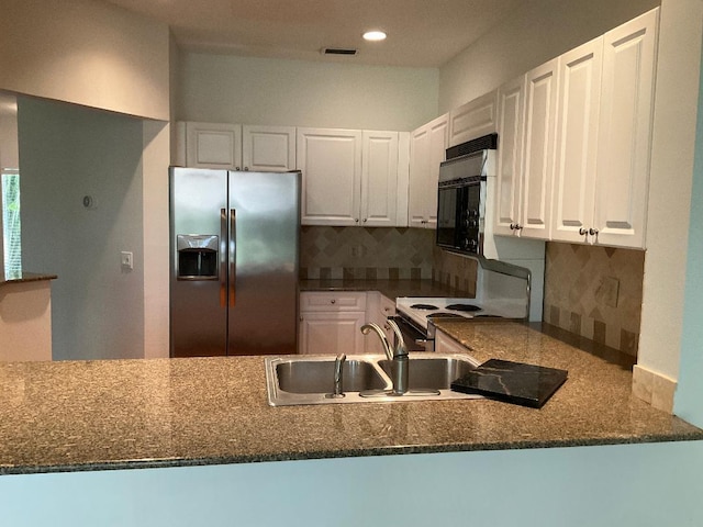 kitchen with visible vents, stainless steel refrigerator with ice dispenser, white cabinetry, white range with electric stovetop, and black microwave