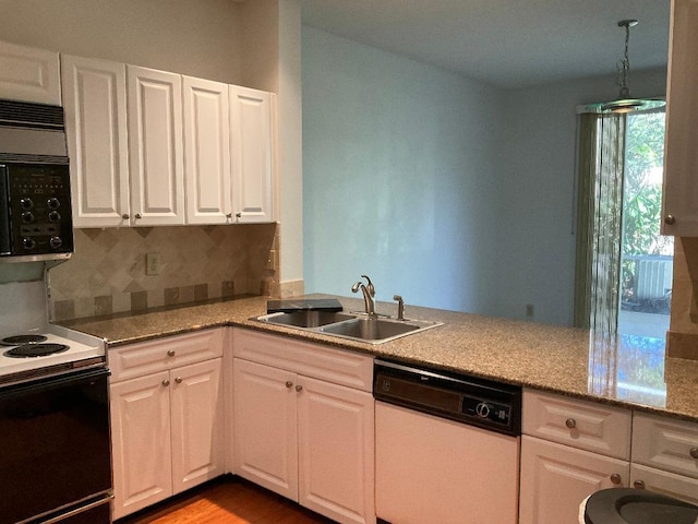 kitchen with electric range, a sink, white cabinets, black microwave, and dishwasher