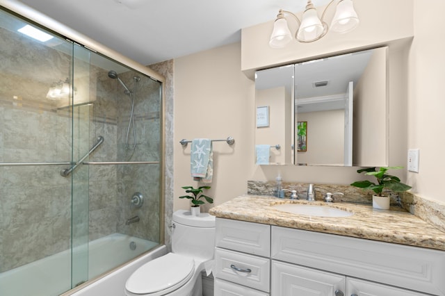 bathroom featuring enclosed tub / shower combo, visible vents, toilet, and vanity