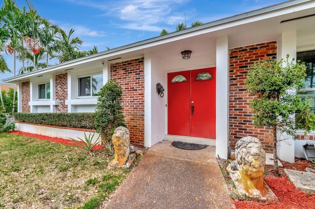 property entrance with brick siding