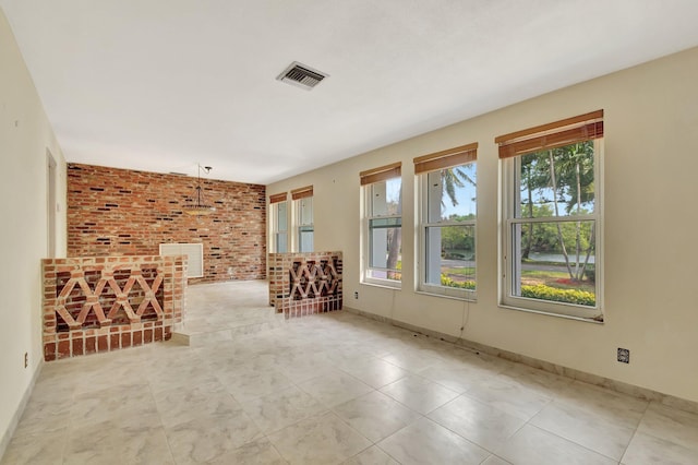 unfurnished room featuring baseboards and visible vents